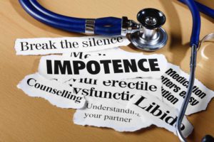 Press headlines on impotence issues and what to do about them, with a stethoscope, on a wooden desk.