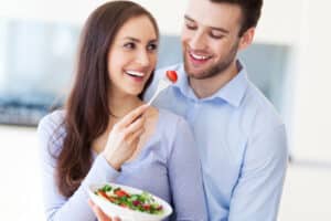 A man and woman sharing a salad