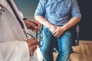 A doctor talking to a man about testicular pain