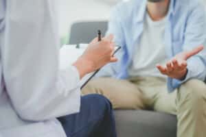 A doctor talking to a man about sperm retrieval in Chattanooga, TN