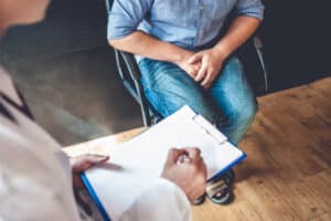 A urologist talking to a man about vasectomy reversal and sperm retrieval